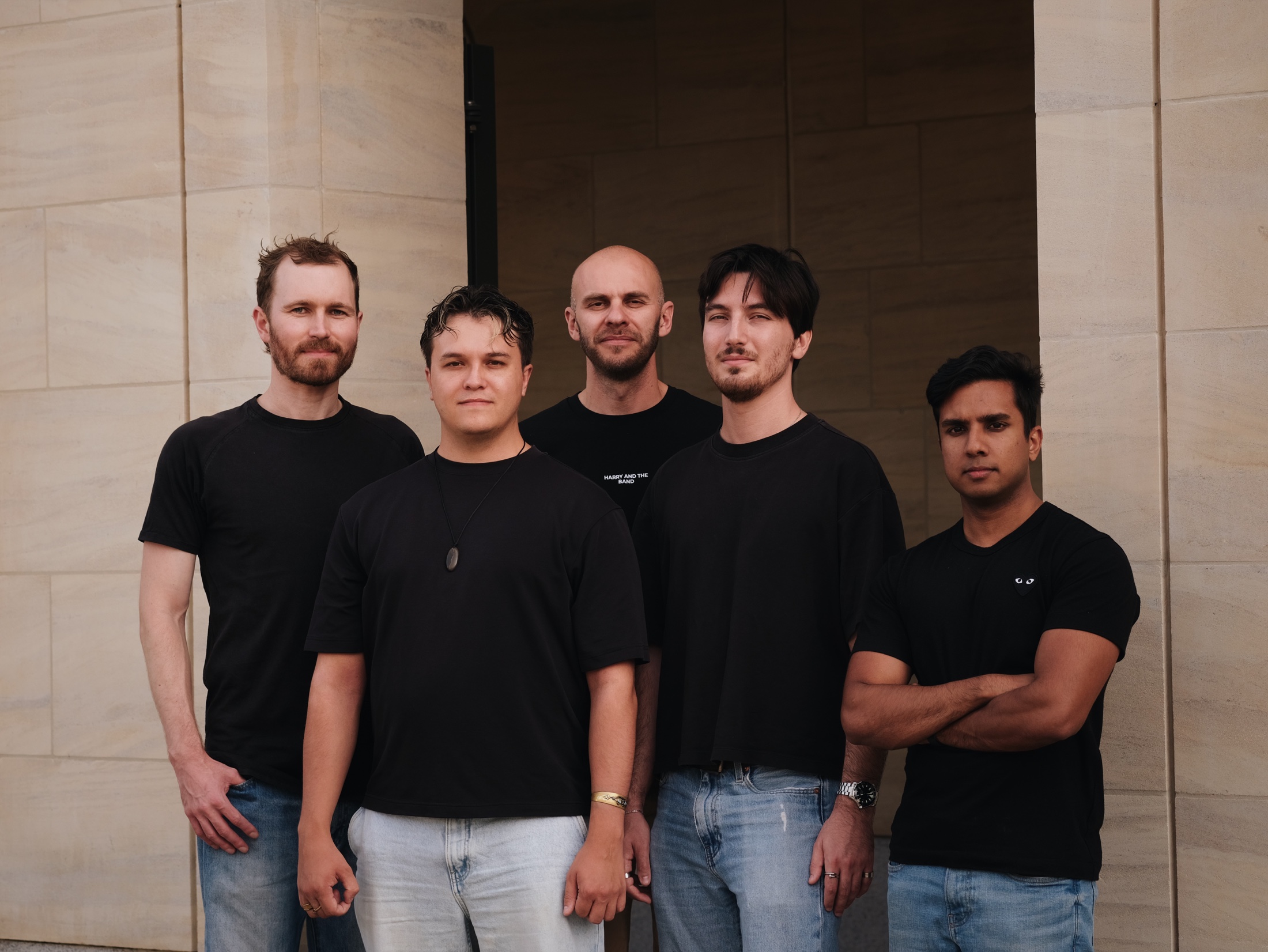 Members of the Amorphous team standing together outside a stone building